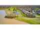 A stunning aerial view of a community with a lush golf course and serene ponds at 10846 Hamilton Pass, Fishers, IN 46037