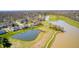 Overhead view of homes nestled beside a golf course and tranquil ponds at 10846 Hamilton Pass, Fishers, IN 46037