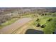 A panoramic aerial view of the golf course with a pond offering beautiful views of the community at 10846 Hamilton Pass, Fishers, IN 46037