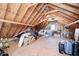 Spacious attic with unfinished walls and a variety of stored items at 10846 Hamilton Pass, Fishers, IN 46037