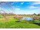Picturesque yard features pond views, manicured lawn and mature trees at 10846 Hamilton Pass, Fishers, IN 46037
