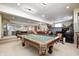 Large finished basement features a pool table and multiple seating areas at 10846 Hamilton Pass, Fishers, IN 46037