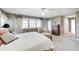 Relaxing bedroom showcasing a bed, chair with ottoman, and natural light from the window at 10846 Hamilton Pass, Fishers, IN 46037