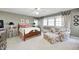 Comfortable bedroom featuring a bed, sitting area, and ample natural light at 10846 Hamilton Pass, Fishers, IN 46037