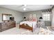 Well-lit bedroom showcasing a comfortable bed, dresser, and side tables with lamps at 10846 Hamilton Pass, Fishers, IN 46037