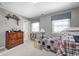 Comfortable bedroom with two beds, a bookshelf, and a decorative dresser at 10846 Hamilton Pass, Fishers, IN 46037