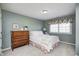 Charming bedroom featuring a decorative dresser, soft carpet and a large window with floral valance at 10846 Hamilton Pass, Fishers, IN 46037
