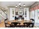 Formal dining room with a view of the living room, stairs, and backyard at 10846 Hamilton Pass, Fishers, IN 46037