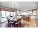 Bright dining area leading to the kitchen, offering access to outdoor seating at 10846 Hamilton Pass, Fishers, IN 46037