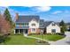 Attractive home boasts green shutters, manicured landscaping, and a classic design, creating a welcoming curb appeal at 10846 Hamilton Pass, Fishers, IN 46037