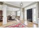 Welcoming foyer showcasing hardwood floors, columns, and a glimpse into the dining room at 10846 Hamilton Pass, Fishers, IN 46037
