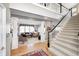 Grand foyer with staircase, hardwood floors, and views into the living room with abundant natural light at 10846 Hamilton Pass, Fishers, IN 46037
