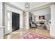Inviting foyer with hardwood floors, black front door, and elegant details leading to a cozy living space at 10846 Hamilton Pass, Fishers, IN 46037