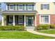 Charming front porch with brick accents and green shutters surrounded by manicured landscaping and a walkway at 10846 Hamilton Pass, Fishers, IN 46037