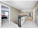 Bright hallway featuring neutral carpet, white trim, and views into adjacent rooms at 10846 Hamilton Pass, Fishers, IN 46037