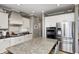 Beautiful kitchen with granite island, stainless steel appliances and custom white cabinets at 10846 Hamilton Pass, Fishers, IN 46037
