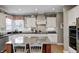 Charming kitchen featuring a granite island, stainless appliances, and custom white cabinets at 10846 Hamilton Pass, Fishers, IN 46037