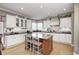 Bright kitchen with custom cabinets, granite countertops, and a central island at 10846 Hamilton Pass, Fishers, IN 46037