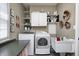 Bright laundry room with modern washer and dryer and ample shelving at 10846 Hamilton Pass, Fishers, IN 46037