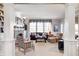 Cozy living room featuring a fireplace, built-in shelving, and large windows that provide ample natural light at 10846 Hamilton Pass, Fishers, IN 46037