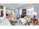 Bright living room with hardwood floors, a fireplace, and an open layout connecting to the dining area at 10846 Hamilton Pass, Fishers, IN 46037