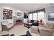 Inviting living room with a brick fireplace, built-in bookcases, and a large window overlooking the yard at 10846 Hamilton Pass, Fishers, IN 46037