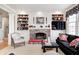 Charming living room with brick fireplace, custom built-ins, and comfortable seating arrangement at 10846 Hamilton Pass, Fishers, IN 46037