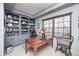 Traditional office featuring custom built-in bookshelves and large windows at 10846 Hamilton Pass, Fishers, IN 46037