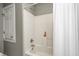 Clean bathroom with a shower featuring white tiled walls and a neutral shower curtain at 10846 Hamilton Pass, Fishers, IN 46037