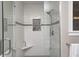 Elegant glass enclosed shower features white subway tile, gray accent strip, and a convenient built in shelf at 10846 Hamilton Pass, Fishers, IN 46037