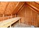 View of an attic with wooden beams and a workbench at 10880 N 23Rd St, Elwood, IN 46036