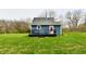 A spacious backyard featuring a new black deck and lush greenery at 10880 N 23Rd St, Elwood, IN 46036