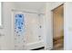 Bathroom with shower/tub combo and shower curtain with a view into the open concept home at 10880 N 23Rd St, Elwood, IN 46036