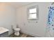 Bright bathroom with a toilet, vanity, and shower, featuring modern fixtures at 10880 N 23Rd St, Elwood, IN 46036