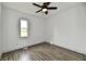 A blank bedroom boasts new floors, fresh paint, and a modern ceiling fan at 10880 N 23Rd St, Elwood, IN 46036