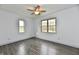 A bright bedroom with new floors, natural light, and a ceiling fan at 10880 N 23Rd St, Elwood, IN 46036