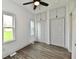 Bedroom features hardwood floors, built-in closets, natural light, and ceiling fan at 10880 N 23Rd St, Elwood, IN 46036
