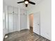 This spacious bedroom features hardwood floors, built-in closets, and modern ceiling fan at 10880 N 23Rd St, Elwood, IN 46036