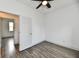 Empty bedroom with hardwood floors, ceiling fan, and white trim at 10880 N 23Rd St, Elwood, IN 46036