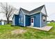 Charming blue home featuring a new roof, fresh landscaping, and a matching storage shed at 10880 N 23Rd St, Elwood, IN 46036