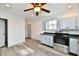 Kitchen with gray cabinets, stainless steel appliances, a ceiling fan and laminate flooring at 10880 N 23Rd St, Elwood, IN 46036