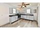 This spacious kitchen boasts gray cabinets, modern appliances, and a stylish ceiling fan at 10880 N 23Rd St, Elwood, IN 46036