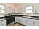 Well-lit kitchen features ample cabinet space, stainless steel appliances, and a double basin sink at 10880 N 23Rd St, Elwood, IN 46036