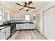 This kitchen features gray cabinets, modern appliances, a ceiling fan and plenty of counter space at 10880 N 23Rd St, Elwood, IN 46036