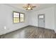 An airy living room features new flooring, a ceiling fan, and natural light at 10880 N 23Rd St, Elwood, IN 46036