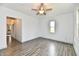 Bright living room with fresh floors, natural light, and a modern ceiling fan at 10880 N 23Rd St, Elwood, IN 46036