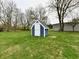 Exterior shot of a charming blue and white storage shed in a grassy yard at 10880 N 23Rd St, Elwood, IN 46036