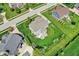 Back aerial view features an outdoor patio with a fire pit, dining, and seating spaces at 11509 Wildlife Ct, Zionsville, IN 46077