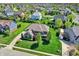 An aerial view showcasing a home in a well-planned community with lush green lawns and mature trees at 11509 Wildlife Ct, Zionsville, IN 46077