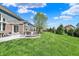 Expansive backyard featuring a patio with a fire pit and lush lawn at 11509 Wildlife Ct, Zionsville, IN 46077